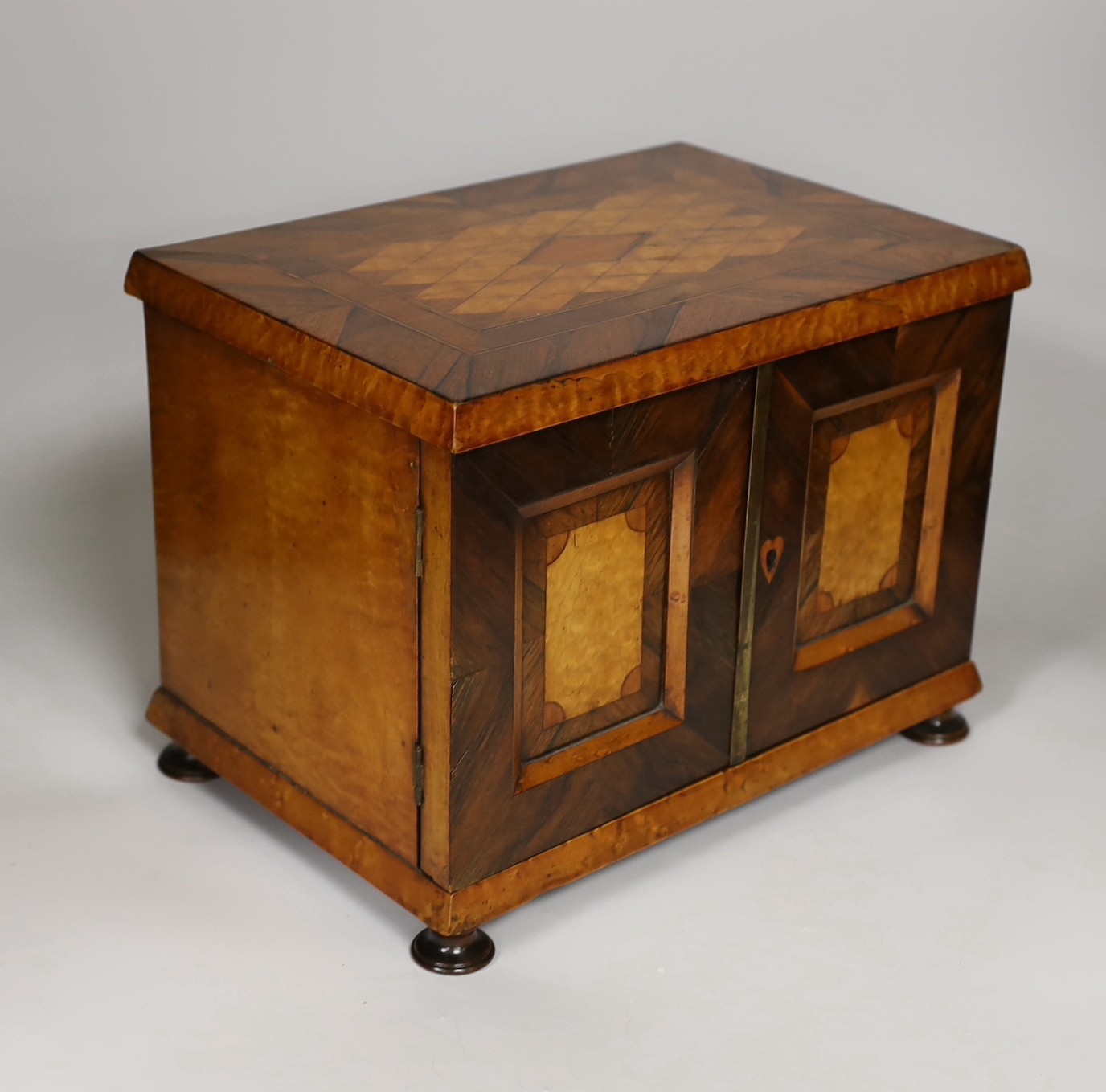 A 19th century rosewood and bird’s eye maple table cabinet. 24cm high. 32cm wide, 23cm deep